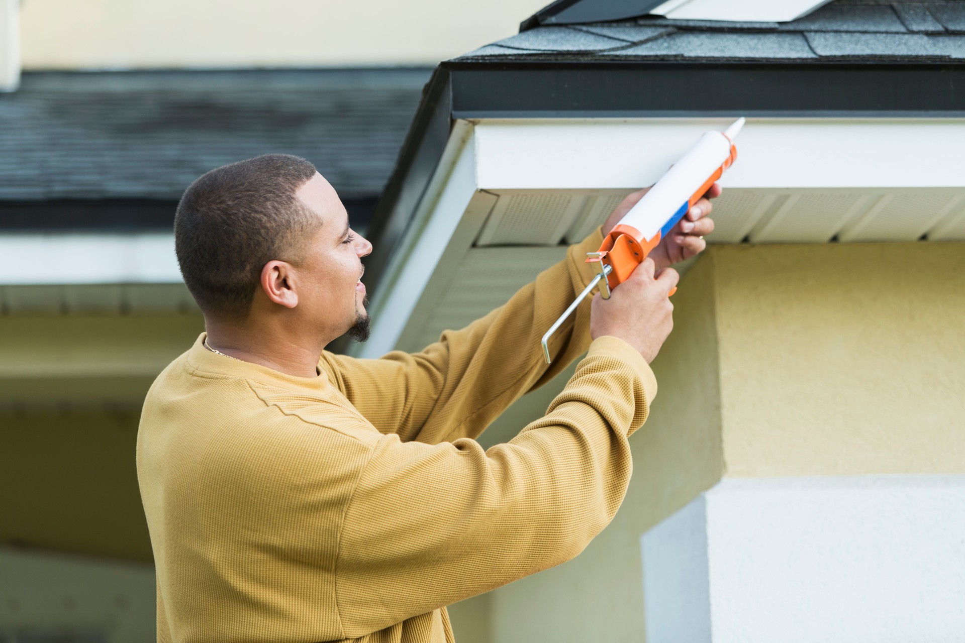 Young handyman doing house repairs
